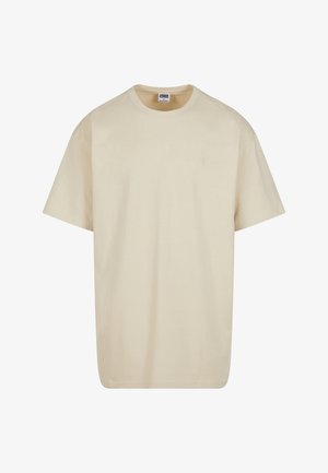 Beige cotton t-shirt with a crew neck, short sleeves, and a relaxed fit. Features a plain design without patterns or accents.