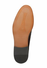 Schwarze Ledersohle mit einem glatten, hellbraunen Mittelteil, versehen mit strukturierten Gummigrip-Linien und dem eingeprägten Logo "WITTCHEN handmade".