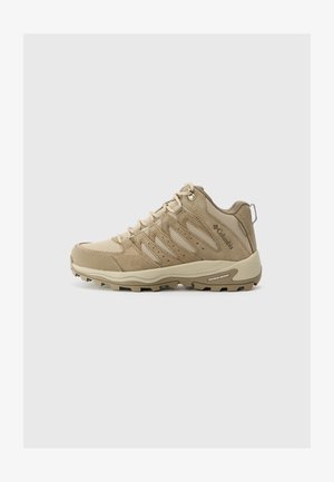 Beige Wanderschuhe mit einem Obermaterial aus Netz und Wildleder, strukturierten Details, verstärkter Zehenpartie und einer robusten Gummisohle mit einem Grippattern.