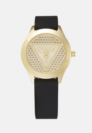 Gouden horloge met een driehoekige wijzerplaat, voorzien van een gaasontwerp en logo, zwarte siliconen band en drie gouden wijzers voor het bijhouden van de tijd.