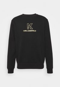 Felpa nera realizzata in tessuto morbido, con un design del logo dorato che presenta la lettera "K" e il testo "Karl Lagerfeld". Collo rotondo e maniche lunghe.