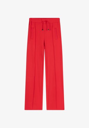 Rode, wijde broek gemaakt van zachte stof, met een drawstring tailleband en twee voorzakken met minimale details.