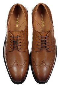 Brown leather dress shoes with wingtip detailing, round toe, and laces. Smooth texture with perforated accents and a black sole.