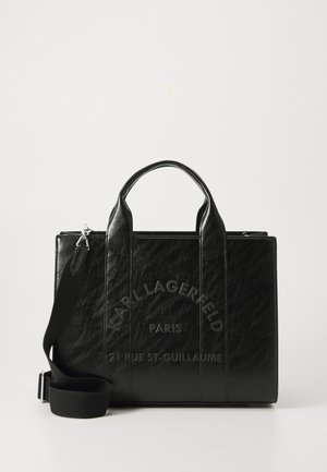 Black leather tote bag with textured surface, dual top handles, adjustable shoulder strap, and embossed brand logo on the front.
