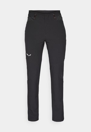 Black outdoor pants made of stretch fabric, featuring two front pockets, tapered legs, and a logo accent on the thigh.