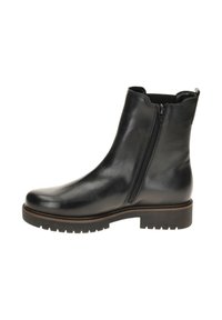 Zwarte leren enkelboot met een gladde afwerking, ritssluiting aan de zijkant, dikke rubberen zool en subtiele stikdetails langs de randen.