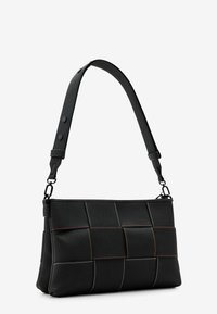 Black synthetic bag with a woven texture, featuring contrasting stitching lines in red, orange, and white. Adjustable shoulder strap included.