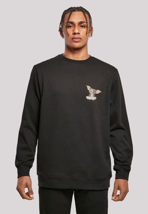 Sort sweatshirt lavet af bomuld, med et lille, farverigt tegneseriehund grafisk tryk på venstre bryst. Ribbestrikkede manchetter og hals. Simpelt design.