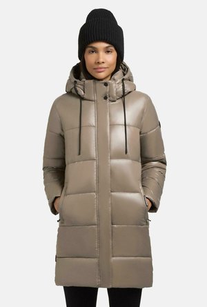 Padded parka in light beige with a nylon exterior, featuring a hood, front zip, drawstrings, and side pockets. Worn with a black knit beanie.