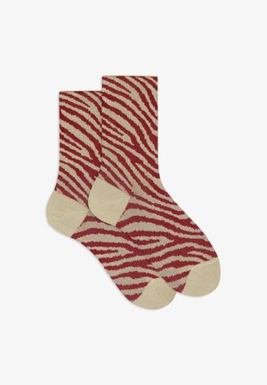 Rot-beige gestreifte Socken mit einem Zebra-Muster, verstärkter Ferse und Spitze in Beige, aus weichem Strickmaterial.