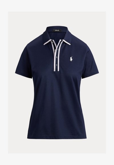 Σκούρο μπλε κοντομάνικο πόλο με γιακά και πατιλέτα με κουμπιά περιμετρικά λευκής επένδυσης, με λευκό κεντητό λογότυπο παίκτη πόλο στο στήθος.