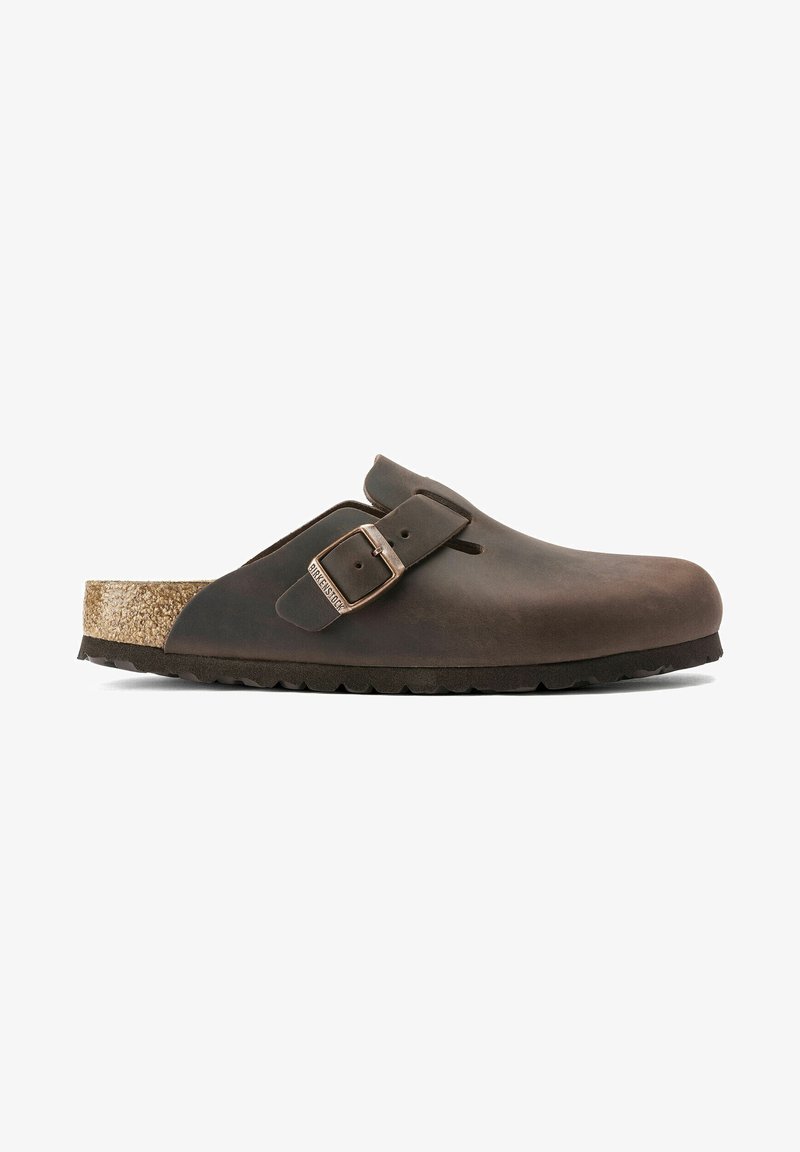 Brown leather clog with a cork footbed, adjustable buckle, smooth exterior, rounded shape, and textured rubber outsole.