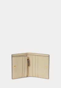 Beige leather wallet open to show six card slots, a zippered coin pocket, and snap button closures on each side.