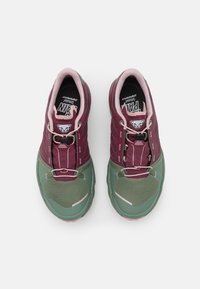 Chaussures de sport en bourgogne et vert, avec un matériau en maille et synthétique, présentant une boîte à orteils texturée, des accents renforcés et des lacets élastiques.