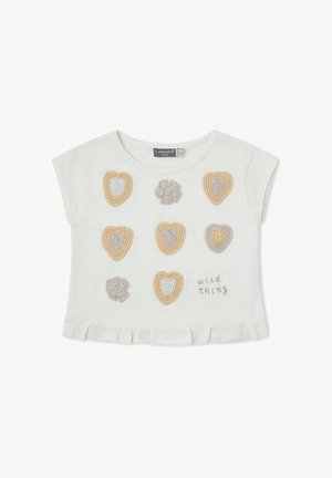 Camiseta blanca para niño pequeño con dobladillo con volantes, con nueve corazones y flores de crochet en tonos beige y gris y el texto "wild thing" en el frente.