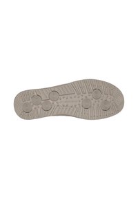 Suela de zapato en goma beige clara con superficie texturizada, que presenta patrones circulares y ranuras para tracción y estabilidad.