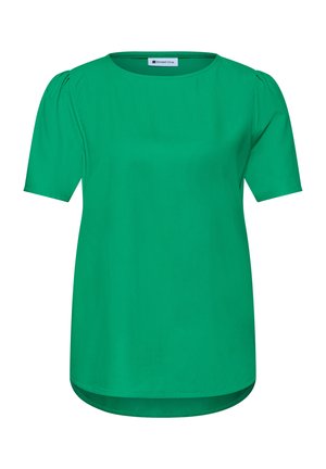 Blouse verte à manches courtes avec col rond et léger effet bouffant aux épaules, avec un ourlet incurvé et un tissu lisse.