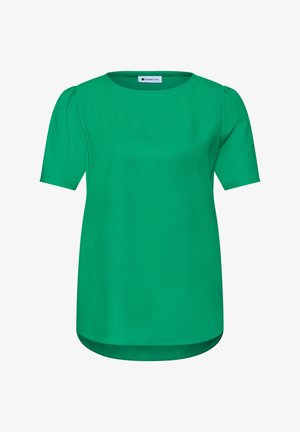 Blouse verte à manches courtes avec col rond et léger effet bouffant aux épaules, avec un ourlet incurvé et un tissu lisse.