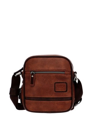 Compact brown leather crossbody bag with front zip pocket, adjustable dark strap, and stitched rectangular patch on smooth textured surface.