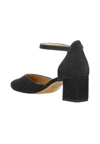 Scarpe con tacco in suede nero con punta arrotondata, cinturino alla caviglia e tacco quadrato. Presentano una fodera interna liscia e cuciture a contrasto.