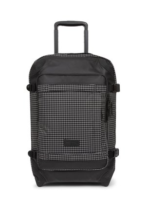 Black wheeled backpack with a grid pattern in white. Made of durable fabric, featuring a zippered front pocket and sturdy handle.