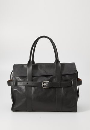 Black leather duffel bag with two handles, a belted strap detail, and smooth texture. Features a flap closure and minimalistic design.