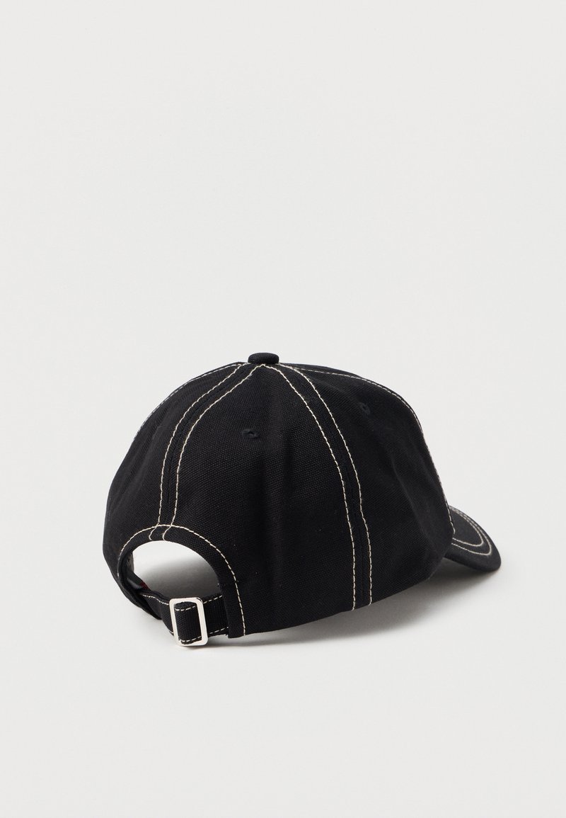 Black baseball cap with white stitching, adjustable metal buckle strap, shown from the back on a plain light background.