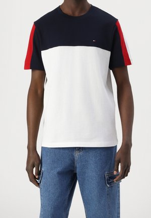 Cotton T-shirt featuring a navy upper panel, white center, and red sleeve accents. Short sleeves and crew neck design.