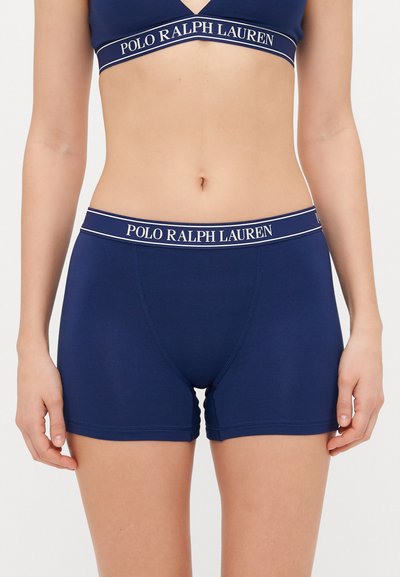 Navyblauwe boxershorts met geribbelde textuur, elastische tailleband met "POLO RALPH LAUREN" branding in het wit, lengte tot aan de dij, aansluitend ontwerp.