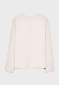 Jasnobeżowy, luźny sweter wykonany z miękkiego dzianinowego materiału, z okrągłym dekoltem, opuszczonymi rękawami i prostym dołem.