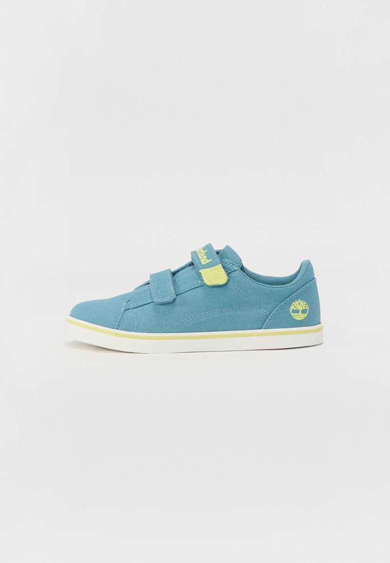 Blue fabric sneaker with two Velcro straps, white sole, and a yellow accent on the strap. Features a logo on the side.