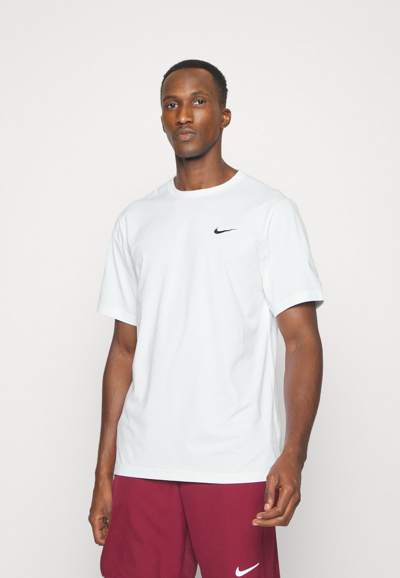 White short-sleeve T-shirt made of cotton, featuring a black Nike logo on the chest. Simple round neckline and relaxed fit.
