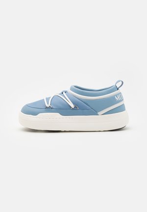Light blue shoe in a low-top design, featuring a smooth textured upper, white accents, and a thick white rubber sole with lacing details.