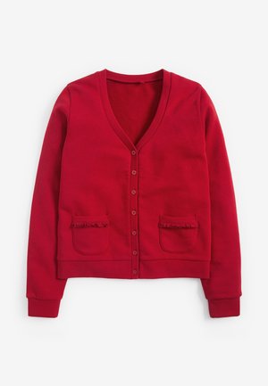 Cardigan boutonné rouge avec col en V et deux poches avant ornées d'un bord à volants, présenté à plat sur un fond blanc.