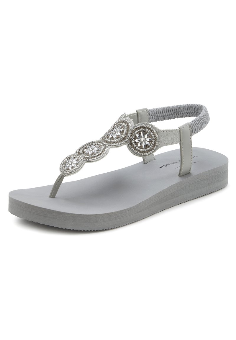 Grijze teenslipper met een gestructureerde enkelband, versierd met zilveren ronde accenten en een gevoerd voetbed voor comfort.