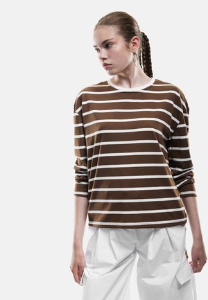 Bruin en wit gestreepte lange mouwen shirt met een ronde hals en een relaxte pasvorm, gecombineerd met losse witte broek. Gladde textuur en casual ontwerp.