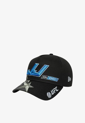 Black baseball cap featuring blue embroidered "JJ" logo, "JON JONES" label, and silver star detail on the visor, with UFC branding.