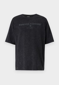 Black cotton t-shirt with short sleeves, crew neck, and a slightly textured finish. Features the text "FOREVER FORWARD" and "EST. 1963" in dark gray.