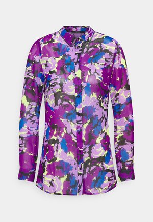 Chemise à manches longues avec col et boutons, ornée d'un motif floral abstrait éclatant aux couleurs violet, bleu, noir et jaune clair.