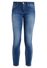 Jeans slim-fit mi-hauteur en denim bleu moyen. Présente un design classique à cinq poches, un léger délavage et des détails cousus le long des coutures.