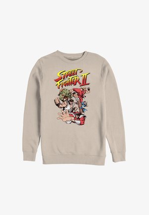 Beżowa bluza z kolorowym logo Street Fighter II oraz pięcioma animowanymi postaciami w pozach bojowych na przodzie.