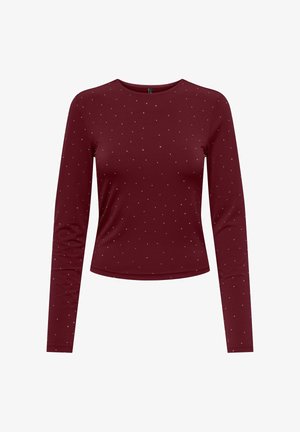 Top bordeaux a maniche lunghe aderente con piccoli pois bianchi distribuiti uniformemente sul tessuto.