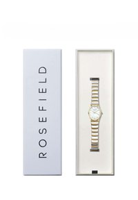 Gold- und silberfarbene Metalluhr mit einem weißen Zifferblatt, das drei Zeiger und Stundenmarkierungen anzeigt, präsentiert in einer weißen Box mit der Aufschrift "ROSEFIELD."