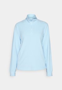 Suéter de manga larga de color azul claro con un alto cuello y una media cremallera. Tejido suave y elástico; cuenta con mangas con puños y costuras laterales.