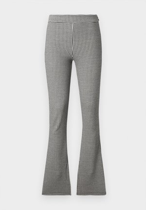 Black and white houndstooth patterned flared trousers with a fitted waistband and smooth fabric texture, stretching from waist to hem.