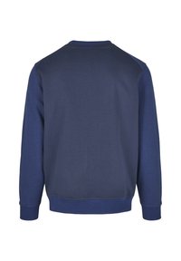 Tumesinise puuvillaseguga dressipluus, mis on varustatud ümara kaelusega, soonikuga mansettide ja alläärega ning raglaanvarrukatega mugavuse tagamiseks.