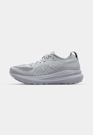 Light gray running shoe with a mesh upper, prominent cushioning sole, and reflective accents. Laces are centrally positioned on the tongue.