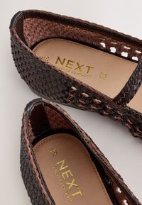 Brown woven leather slip-on shoes with beige insoles branded "NEXT Forever Comfort" in gold lettering, size 5/38.