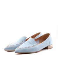 Light blue suede flats with a pointed toe, featuring decorative stitching along the upper and a low wooden heel.