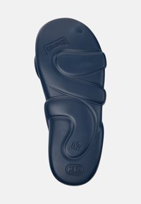 Navy blue rubber sandal sole with an ergonomic design, featuring textured waves and embossed "CAMPER" logo. Size marked as 42.